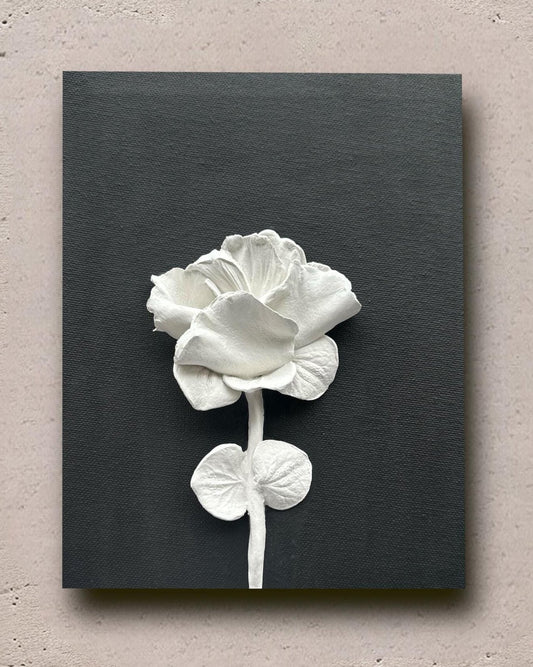 Black canvas with a sculpted 3D Flower made of natural clay. Simple yet stunning.